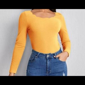 NWOT super cute shirt w/scallop neck - material is a poly blend. Not stretchy.